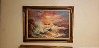 Front view of framed seascape painting on wall