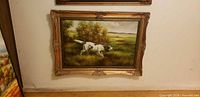 Full view of framed hunting dog landscape painting