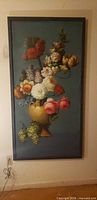 Full view of framed vertical floral still life painting