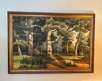 Full view of framed forest landscape painting on wall