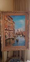 Full view of framed Venetian canal oil painting on easel