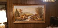 Full view of framed landscape painting on wall