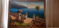 Full view of framed Mediterranean coastal oil painting