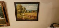 Frontal view of framed landscape painting on wall