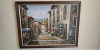 Framed oil painting of Tuscan village street scene