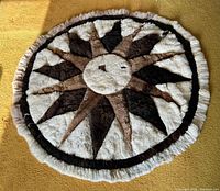 Full overhead view of round fur rug showing complete starburst design and overall condition