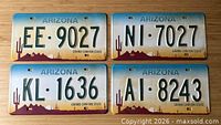 Front view of four Arizona replica plates showing designs and numbers
