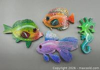 Front view of four hand-painted wooden plaques