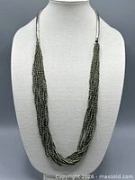 Necklace displayed on bust form showing full length and bead arrangement