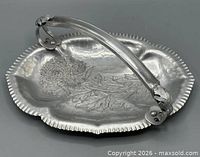 Top view of hammered aluminum tray with chrysanthemum design and handle