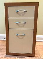 Front view of IKEA 3-drawer cabinet showing natural frame, white fronts, metal pulls
