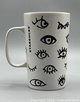 Full side view of mug showing eye motif and Starbucks logo