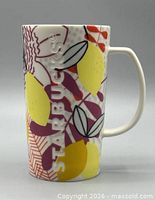 Front view of tall Starbucks mug with lemon/floral design and vertical logo