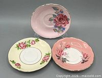Three floral bone china saucers front view