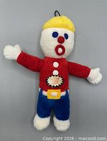 Front view of entire Mr. Bill plush toy hanging upright
