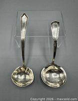 Both sterling silver ladles front view
