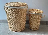 Large and small wicker hampers with lids shown side by side