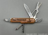 Knife with tools extended showing "Prince Edward Island" engraving