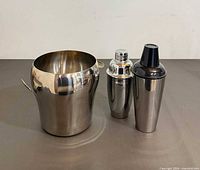 Ice bucket and two cocktail shakers group view