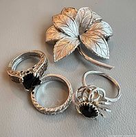 Group shot showing two 925 rings, Sarah Coventry ring, Coro leaf brooch