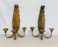 Front view of both sconces upright showing finishes and three arms