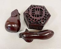 Octagonal box with two carved fruit figures displayed