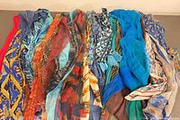 Group shot of all scarves laid side-by-side showing variety of colours and patterns