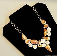 Full necklace on display showing shell design