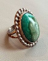 Ring angled view showing stone, bezel, and shank