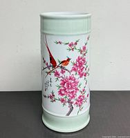 Front view showing entire umbrella stand with bird and blossom design