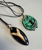 Both pendants with cords displayed side by side