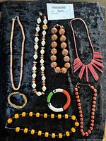 All ten assorted beaded jewellery pieces on black background