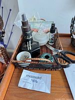 Basket with trinket box, glass dish, flower frog, safety pins visible
