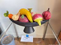 Bowl on stand filled with paper-mâché fruits
