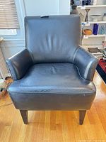 Front view of black leather armchair