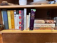Shelf of assorted cookbooks including The New James Beard, The Way to Cook, The Silver Palate Cookbook, The New York Times Cook Book and dessert titles