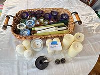 Overview of basket filled with votive holders, candles, metal pieces