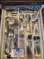 Drawer organizer filled with mixed stainless flatware approx. 60 pieces