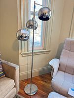Full view of chrome floor lamp with three globe shades