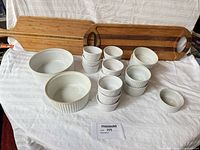 Group shot of all porcelain dishes and both wooden boards
