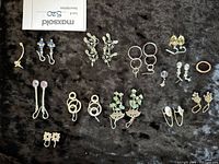 All earrings laid out on black fabric