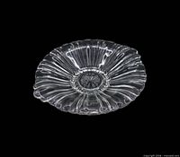 Top view of clear ribbed mint dish with scalloped edge