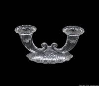 Full view of clear double-light candlestick showing arms, sockets and base