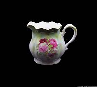 Front view of porcelain pitcher showing floral design and form