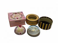 Both paperweights and their corresponding boxes displayed