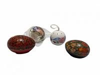 Four ornaments displayed closed