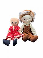 Front view of both cloth dolls seated upright