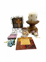 group shot of entire lot showing candle on pedestal, cross plaque on stand, angel figurine, HOPE plaque, notebook and flower sprays