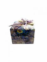 Front view of closed floral music box potpourri holder with ribbon and lace décor