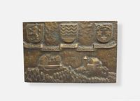 Front view showing raised crests, castle scenes, inscription